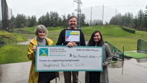 Jocelyn and Lauren (CMHA staff), and Jeff Palmer from Highland Pacific Golf hold up a large cheque of $10,000 made out to CMHA