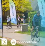 A banner that says "Welcome to Ride Don't Hide! Join us on Sunday June 4, 2023 at Windsor Park" with the image of a couple bikers cycling on a paved pathway. The website URL to register is also visible.